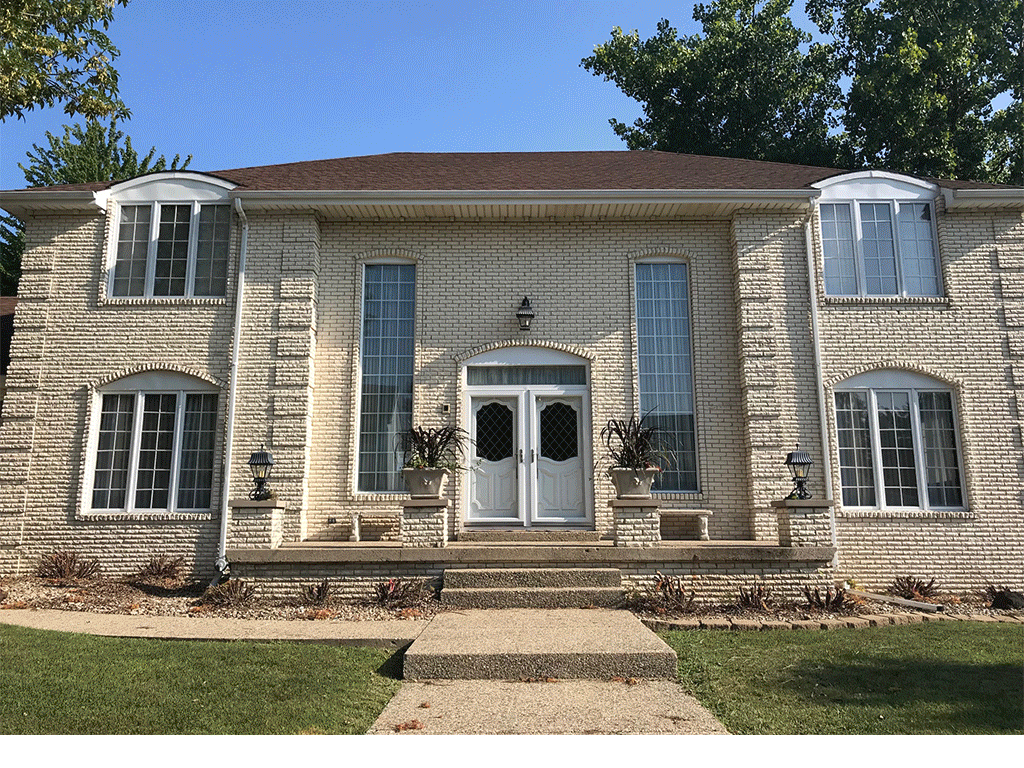 Brick staining transformation — before and after color change on home exterior