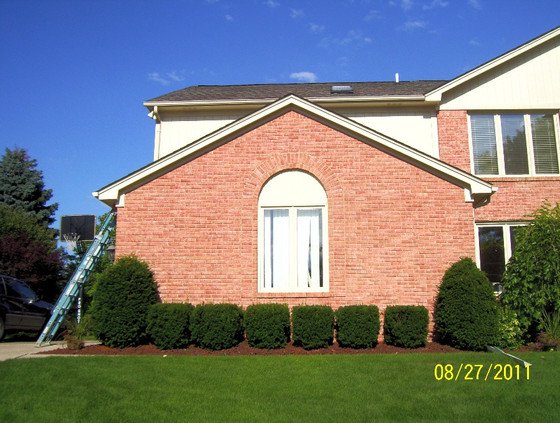 Full home exterior brick staining — complete color transformation to deep red, Portland OR